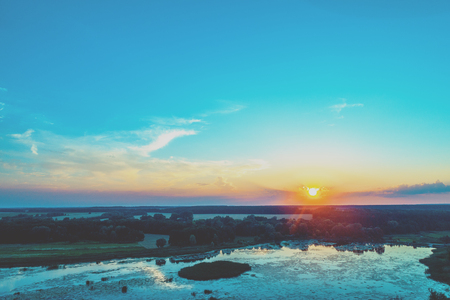 Sunset over the lake. Rural autumn landscape in eveningの写真素材