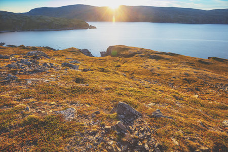 Sunset over the rocky seashore. Beautiful nature Norway. Arctic Bay. Mageroya island. Nordkapp....