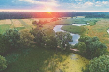 Magical sunset over the countryside. Rural landscape in the evening. Aerial viewの写真素材