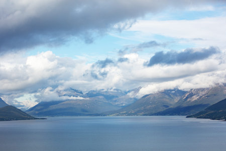 Island on the horizon. Rocks in the sea. Beautiful rocky sea landscape with dramatic cloudy sky....