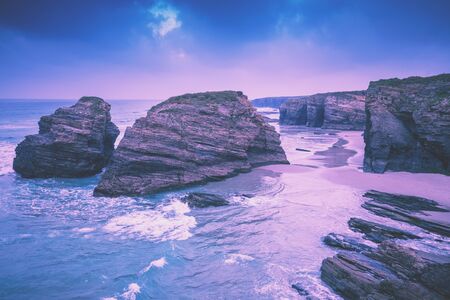 Rocky sea coast at sunrise. Beach Playa de Las Catedrales. Praia de Augas Santas. Ribadeo, Spainの写真素材