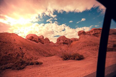 View from a car. Mountain nature landscape. Desert in the early morning. Beautiful sunrise in the mountains. The Judaean Desert. View of a valley with mountains on backdrop. Nature Israelの写真素材