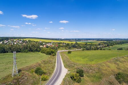 Summer rural landscape, aerial view. View of the village, green fields, and roadの写真素材