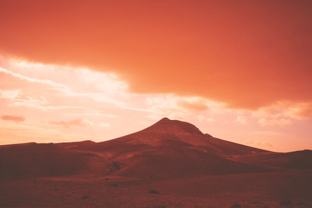 Mountainous desert with dramatic evening cloudy sky at sunset. The Judean Desert in Israel