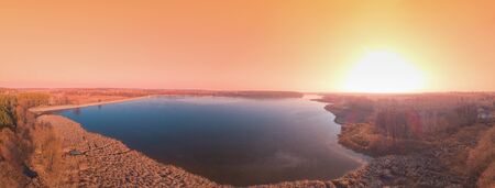 Magical sunset over the lake. Landscape panorama. View from above. Serene lake in the evening. Nature landscapeの写真素材