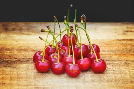 Ripe cherries on a wooden tableの写真素材