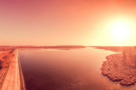 Sunrise over the lake in early spring. Serene lake in the morning. Nature landscape. View from...