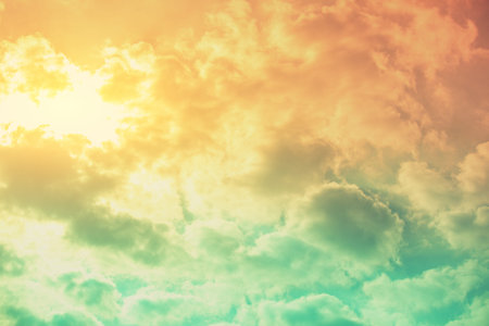 Colorful cloudy sky at sunset. The sun shines through the clouds. Color gradient. The texture of the...