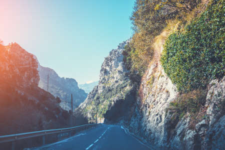 View of beautiful mountain landscape through the windscreen on a sunny day. Driving a car on mountain winding road in National park Picos de Europa. Cantabria, Spain, Europeの写真素材