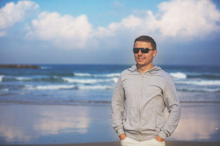 Man walking on the beach. Person going on seaside on a sunny dayの写真素材