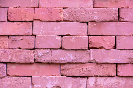 Clay handmade bricks. Abstract pile of bricks background. Pink toned