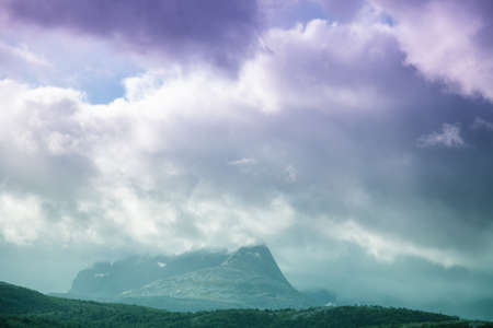 Mountain ridge during sunset. Rocks with dramatic sky in the evening.  Beautiful nature of Norway. Picturesque Scandinavian landscape. Norway, Europeの写真素材