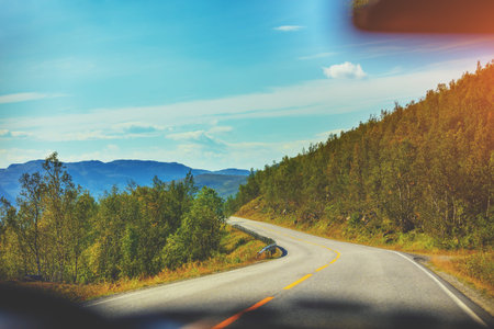 Driving a car on a mountain road. Beautiful harsh nature of Northern Norway. Polar circle. The way...