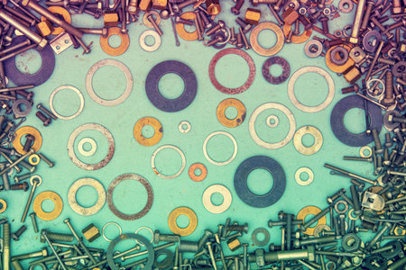 Abstract grunge colorful metallic background from bolts, screws, nuts