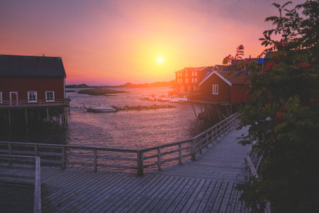 The embankment on the rocky seashore at sunset. Fishing village near the sea. Beautiful nature of...