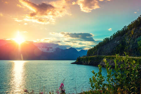 Fjord at sunset. Rocky seashore in the evening. Beautiful nature of Norway. Picturesque Scandinavian landscape. Lofoten islands, Norwayの写真素材