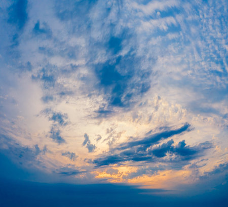 Colorful cloudy sky at sunset over the countryside. Gradient color.