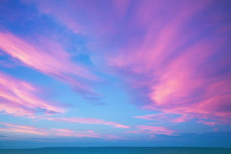 Seascape. Seashore at dramatic blazing sunset. Landscape with sea and bright evening cloudy skyの写真素材