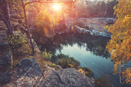 Mountain lake with a rocky shore at sunrise. Canyon in autumnの写真素材