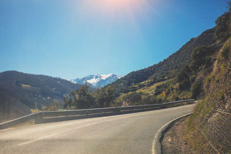 Beautiful mountain landscape in early spring on a sunny day. View through the windscreen. Driving a car on a mountain winding road in National park Picos de Europa. Cantabria, Spain, Europe;の写真素材