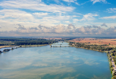 Spring rural landscape. Aerial view. Panoramic view of a lake with beautiful sky