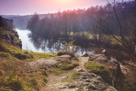 View of a mountain river with a rocky bank in early spring