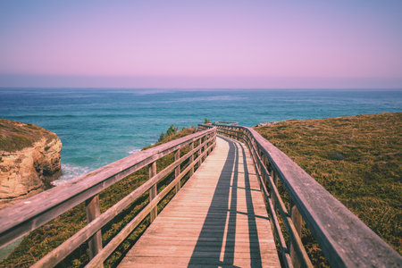 Wooden walkway on the rocky seashore. Photon viewpoint (Miradoiro de Foton) near Cathedrals Beachの写真素材
