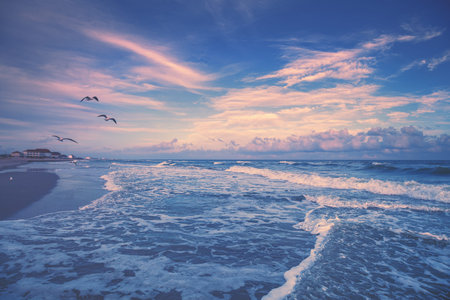 Seascape in the early morning. Sunrise in the sandy beach with beautiful sky