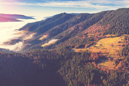 Fantastic view of the tops of the mountain ridge above the cloudsの写真素材