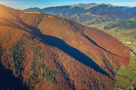 Aerial view of colorful slopes of mountains on a sunny day. View of the mountains in autumn....