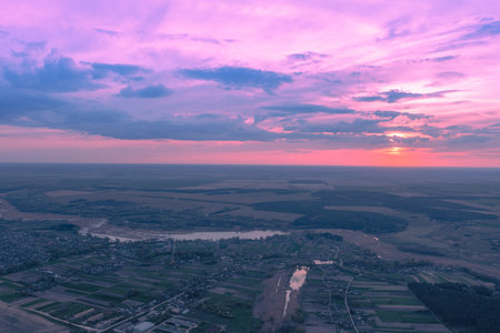 Beautiful sunset in the countryside in spring with the blazing sky. Rural landscape in the evening....