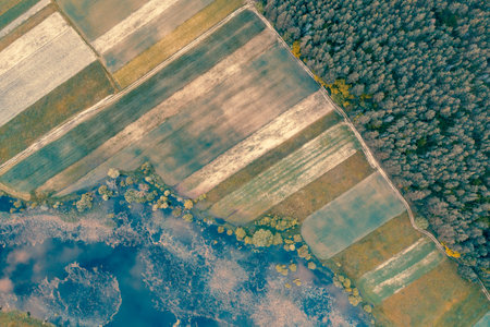 Rural landscape. Aerial top view. View of arable fields, forest, and river in summerの写真素材