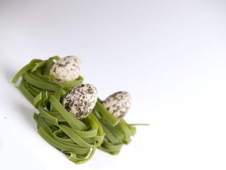 Three eggs in the green pasta nestsの写真素材