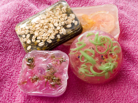 Colorful soap bars laying at pink towel