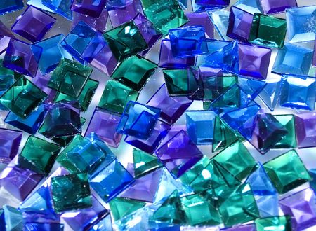 Blue, green and violet glass tiles laying at glassの写真素材
