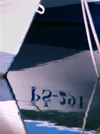 Reflection of boat number in the water