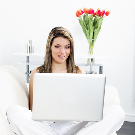 woman on sofa with computerの写真素材