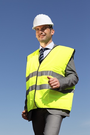 young businessman with hardhat and blue skyの写真素材