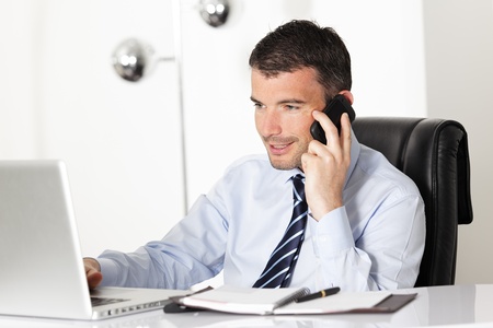 young businessman on the phone in officeの写真素材