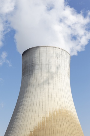 big smokestack of nuclear factory with blue skyの写真素材