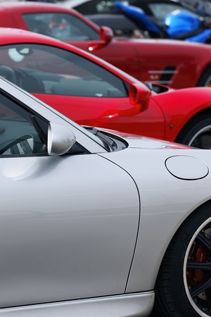 three sport cars in a garage for saleの写真素材