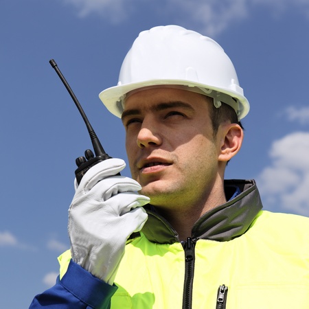 portrait of builder with transmitter in building siteの写真素材