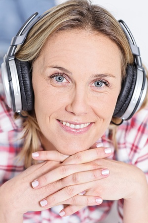 beautiful blond womanlistening music with headphonesの写真素材