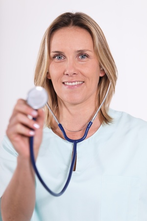 blond woman doctor with stethoscope in hospitalの写真素材