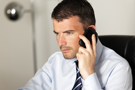 happy businessman on the phone in officeの写真素材