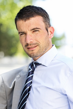 beautiful young businessman with tie outdoor in springの写真素材