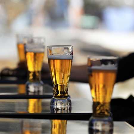 glass of beer on a table in a restaurantの写真素材