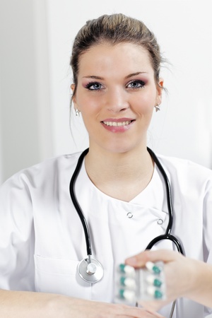 woman doctor with pills and stethoscope in hospitalの写真素材