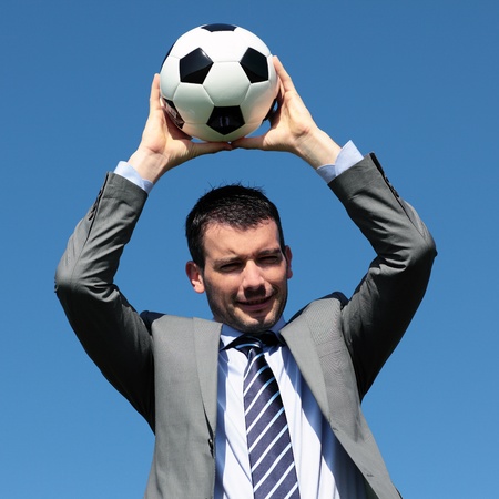 young coach with ball in blue skyの写真素材
