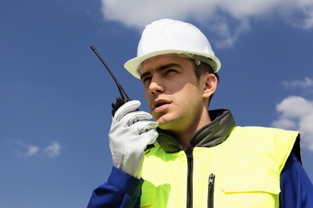 portrait of builder with transmitter in blue skyの写真素材